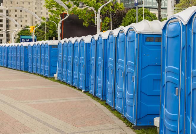 a row of portable restrooms at an outdoor special event, ready for use in Box Elder